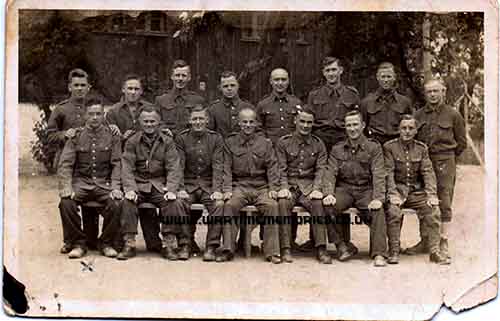 Christopher is seated left of the photo marked with an x.